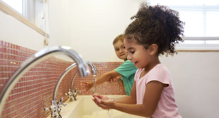 Two children washing their hands