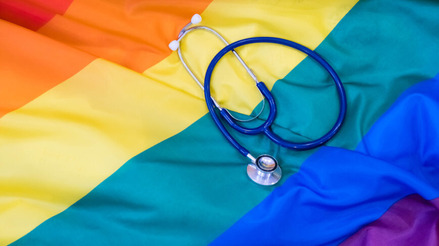 Rainbow flag with stethoscope laid on top
